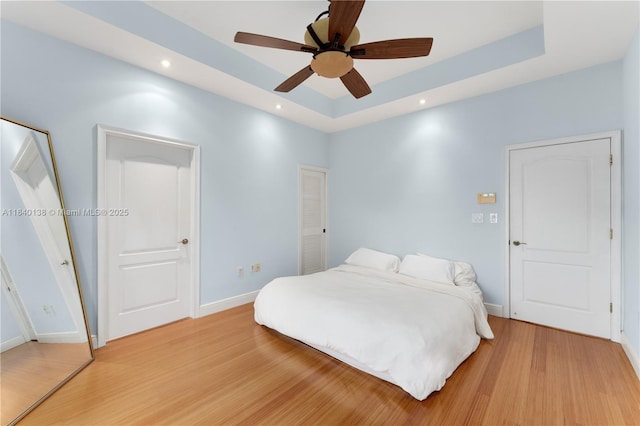 2919 Coconut Ave Unit 1, Miami, FL 33133 - bedroom with light wood-style flooring, a tray ceiling, recessed lighting, and a ceiling fan
