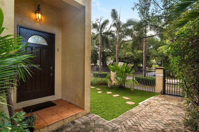 2919 Coconut Ave Unit 1, Miami, FL 33133 - doorway to property featuring stucco siding and a gate