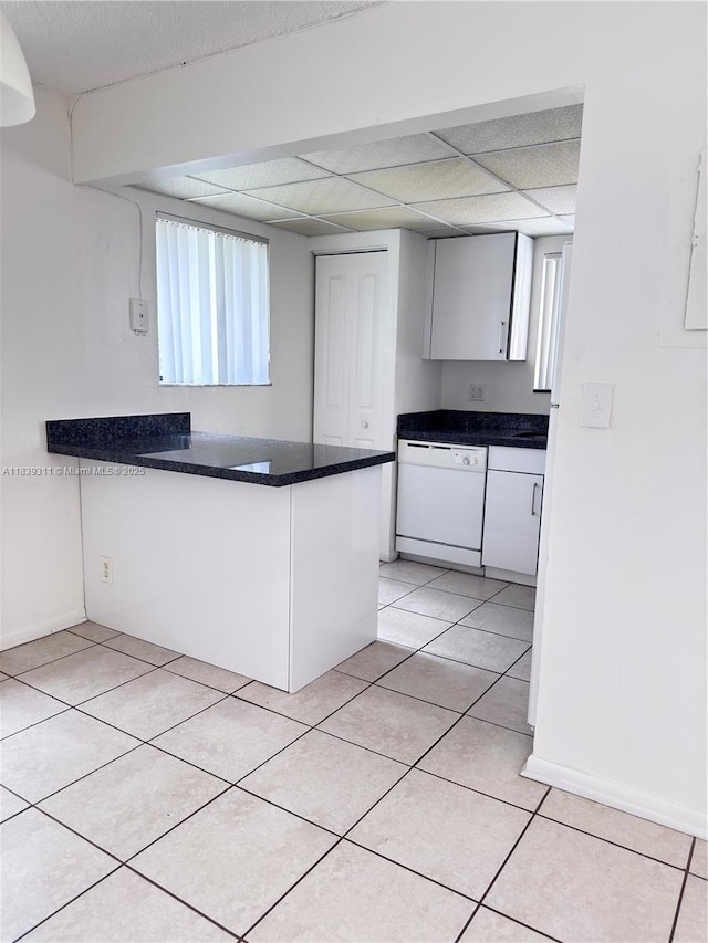 6900 SW 39th St Unit 208J, Davie, FL 33314 - kitchen featuring dishwasher, dark countertops, a peninsula, and white cabinetry