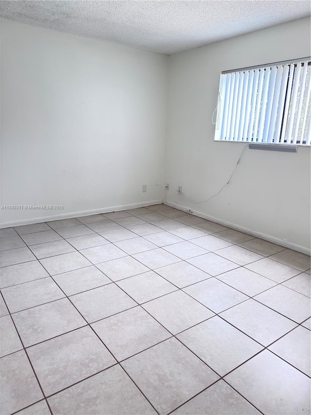 6900 SW 39th St Unit 208J, Davie, FL 33314 - tiled spare room featuring a textured ceiling and baseboards