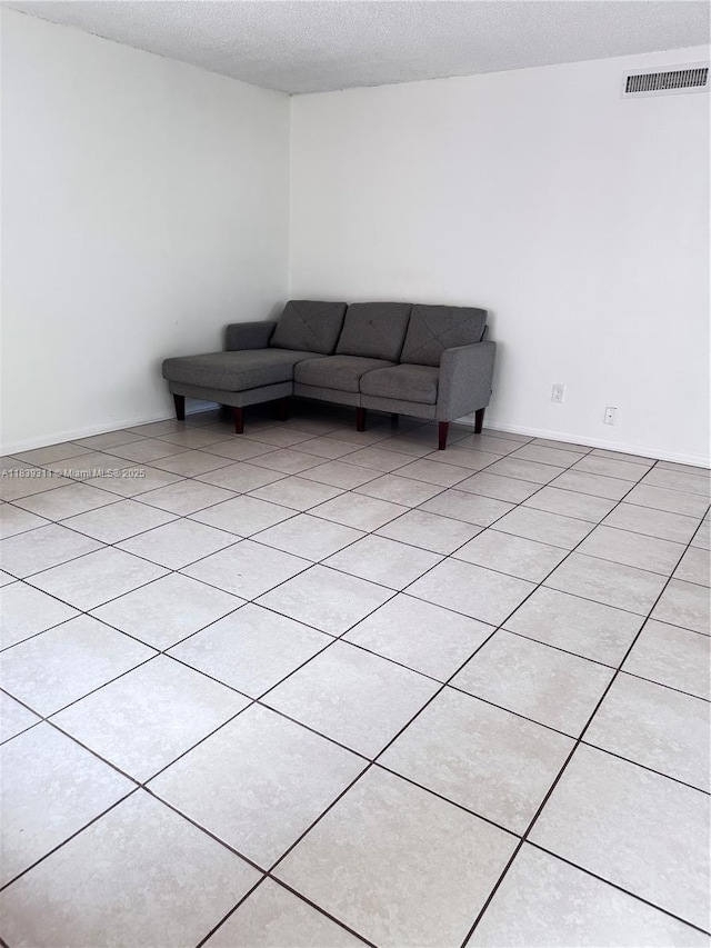 6900 SW 39th St Unit 208J, Davie, FL 33314 - living area featuring a textured ceiling and light tile patterned floors