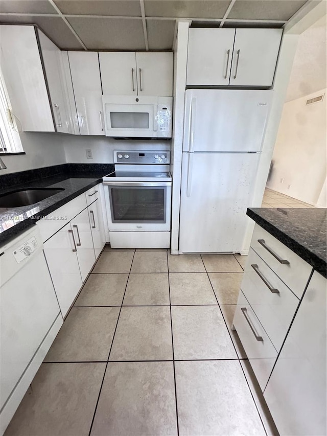 6900 SW 39th St Unit 208J, Davie, FL 33314 - kitchen featuring white appliances, white cabinetry, light tile patterned flooring, and dark stone countertops