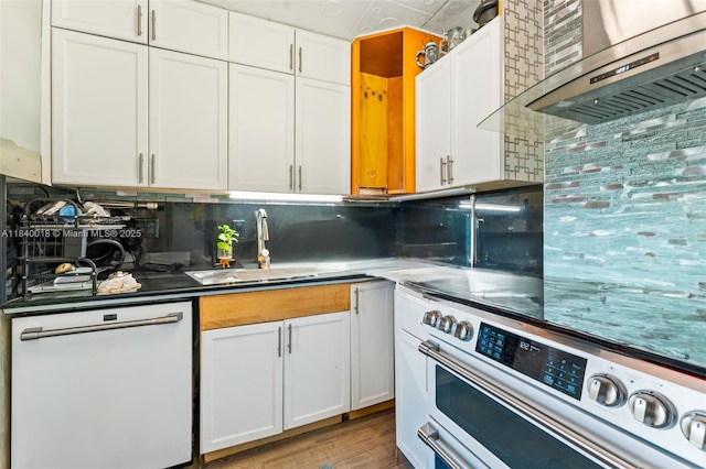 29351 Idaho Rd, Homestead, FL 33033 - kitchen featuring white dishwasher, stainless steel electric range oven, wall chimney range hood, white cabinetry, and decorative backsplash
