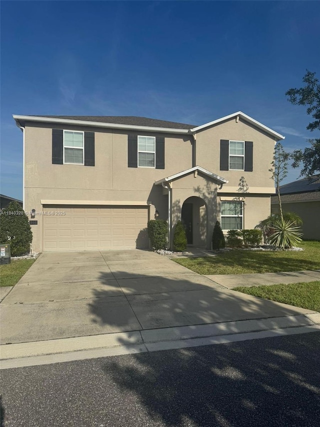 144 Taft Dr, Davenport, FL 33837 - traditional home featuring stucco siding, concrete driveway, and a garage