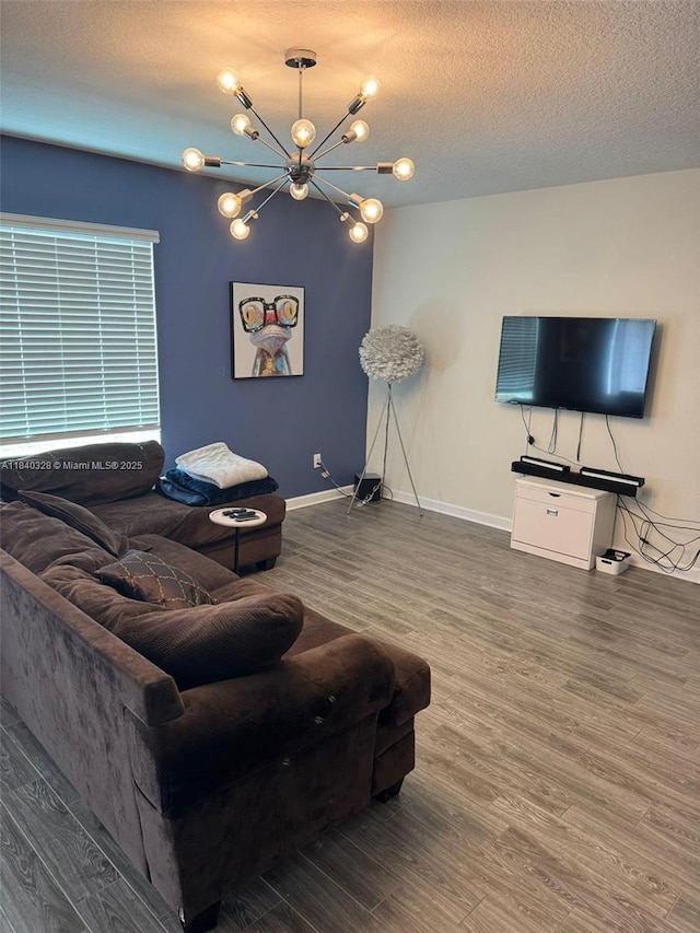 144 Taft Dr, Davenport, FL 33837 - living room featuring wood finished floors, a chandelier, and a textured ceiling