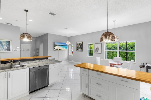 649 Willow Bend Rd, Weston, FL 33327 - kitchen featuring dishwasher, wooden counters, white cabinets, a textured ceiling, and light tile patterned floors