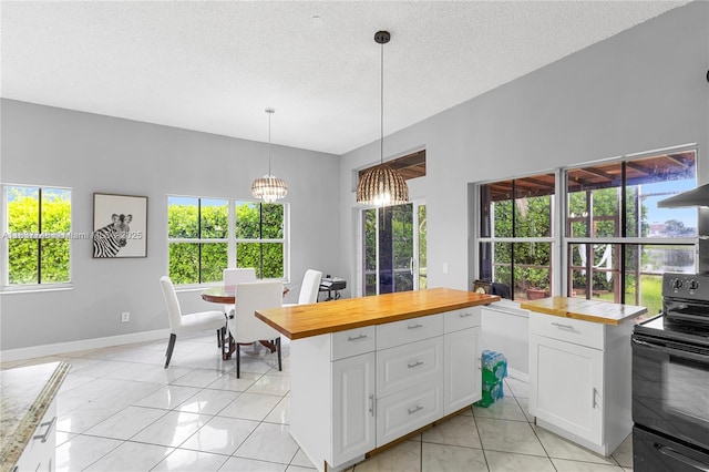 649 Willow Bend Rd, Weston, FL 33327 - kitchen with black / electric stove, wooden counters, white cabinets, pendant lighting, and a textured ceiling