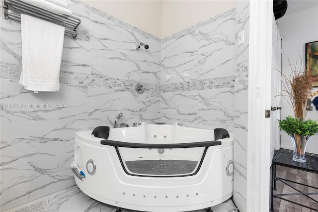 649 Willow Bend Rd, Weston, FL 33327 - bathroom with marble look tiles, tile walls, and a tub with jets