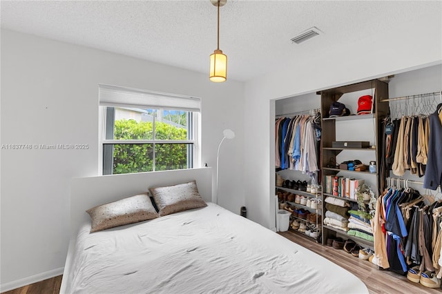 649 Willow Bend Rd, Weston, FL 33327 - bedroom featuring wood finished floors, a closet, and a textured ceiling