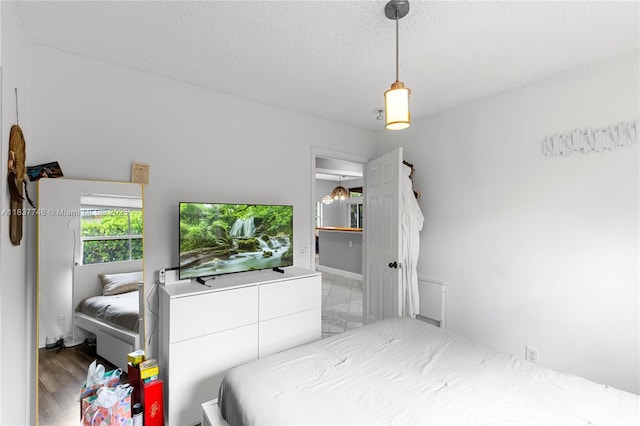 649 Willow Bend Rd, Weston, FL 33327 - bedroom featuring a textured ceiling and wood finished floors