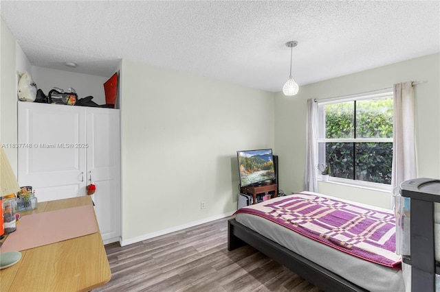 649 Willow Bend Rd, Weston, FL 33327 - bedroom featuring wood finished floors and a textured ceiling