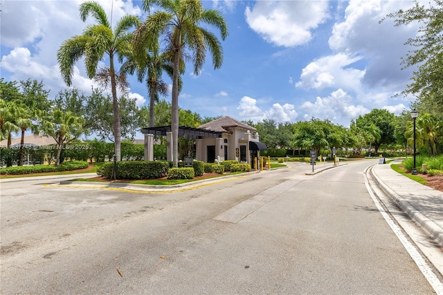 649 Willow Bend Rd, Weston, FL 33327 - view of asphalt road with street lighting, curbs, sidewalks, and a gated entry
