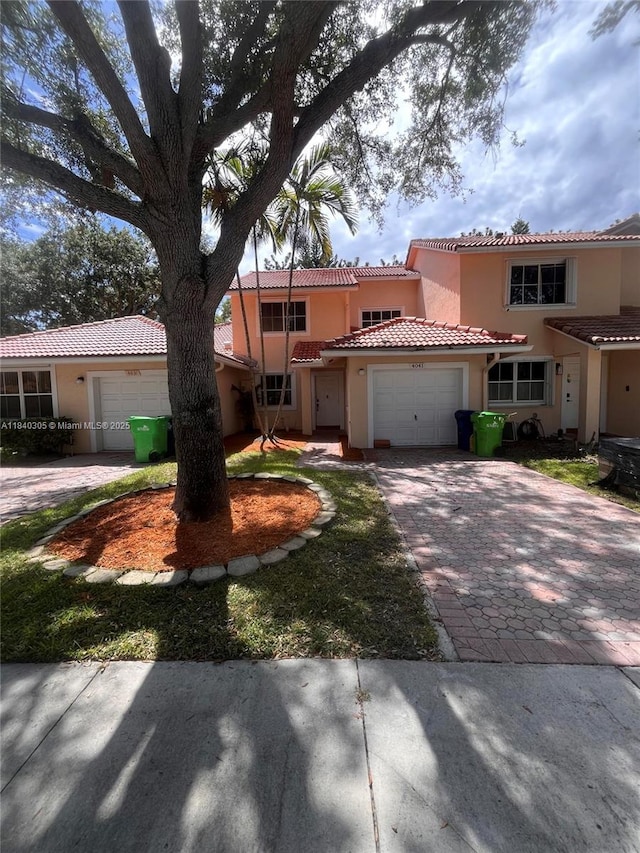 4041 NW 84th Ter Unit 4041, Sunrise, FL 33351 - mediterranean / spanish home featuring an attached garage, driveway, stucco siding, and a tiled roof