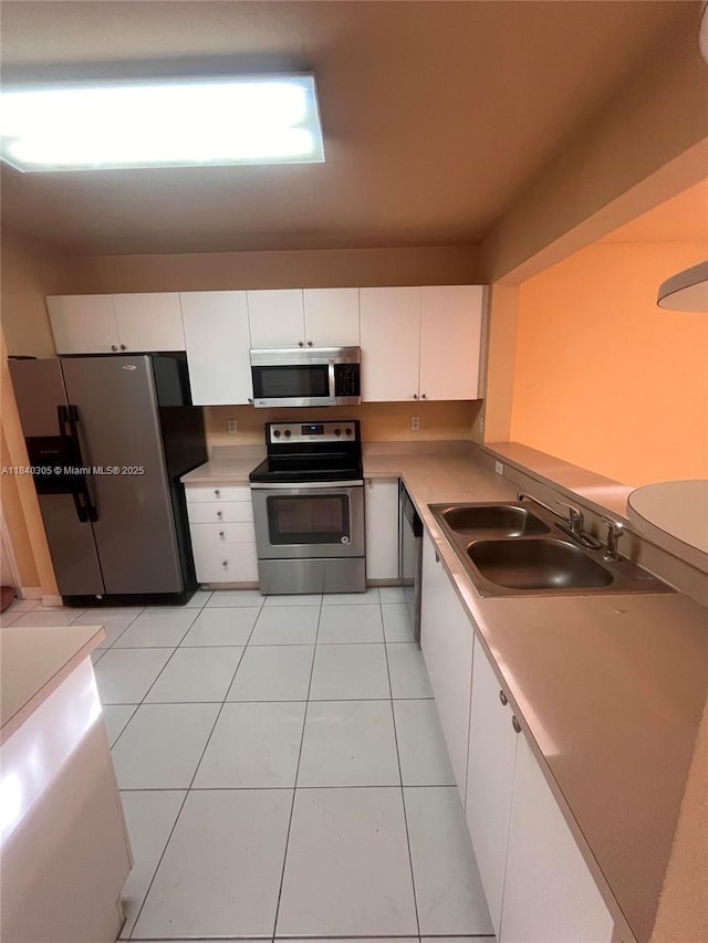 4041 NW 84th Ter Unit 4041, Sunrise, FL 33351 - kitchen featuring stainless steel appliances, white cabinets, light countertops, and light tile patterned floors
