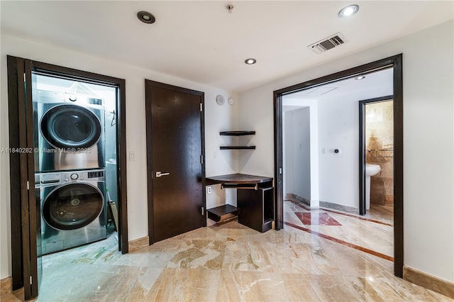 1900 N Bayshore Dr Unit 3715, Miami, FL 33132 - laundry area featuring stacked washing machine and dryer, recessed lighting, and light marble finish floors