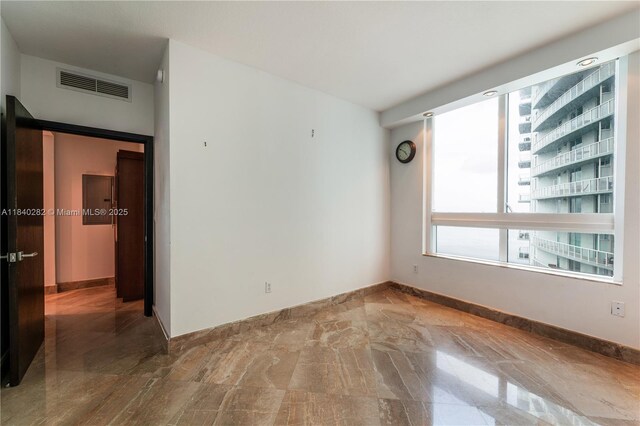 1900 N Bayshore Dr Unit 3715, Miami, FL 33132 - empty room with baseboards and stone finish flooring