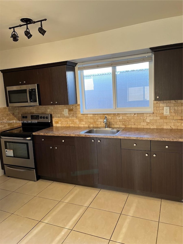 80 W 20th St, Hialeah, FL 33010 - kitchen featuring stainless steel appliances, dark brown cabinets, tasteful backsplash, and light tile patterned floors