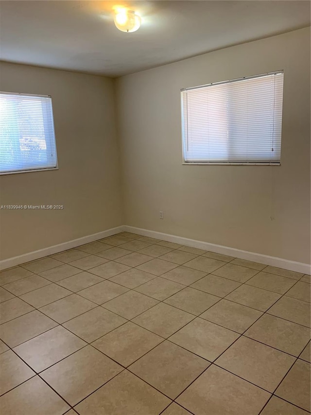 80 W 20th St, Hialeah, FL 33010 - spare room with light tile patterned floors and baseboards