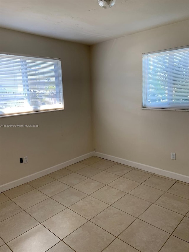 80 W 20th St, Hialeah, FL 33010 - spare room with baseboards and light tile patterned flooring
