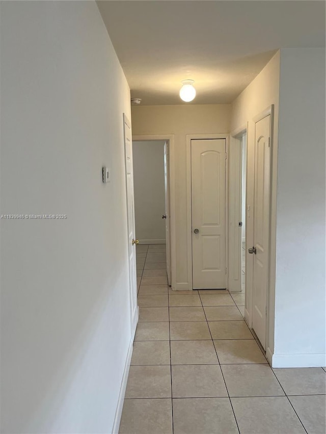 80 W 20th St, Hialeah, FL 33010 - hallway with light tile patterned flooring and baseboards