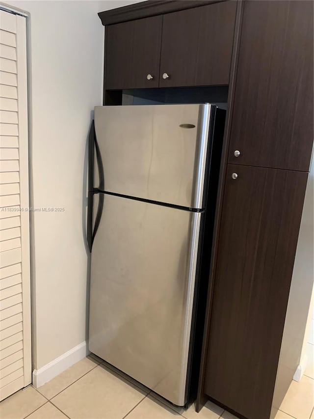 80 W 20th St, Hialeah, FL 33010 - kitchen featuring freestanding refrigerator, dark brown cabinetry, and light tile patterned flooring