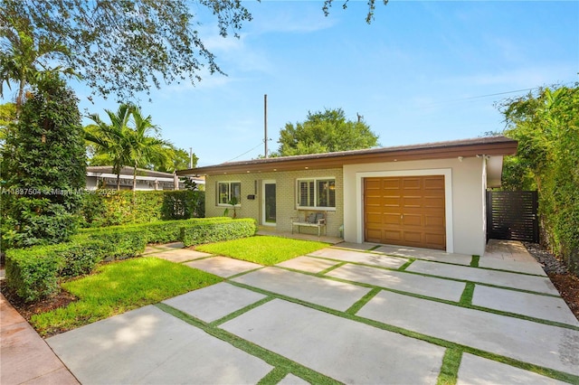 1261 San Miguel Ave, Coral Gables, FL 33134 - single story home with a garage, driveway, and brick siding