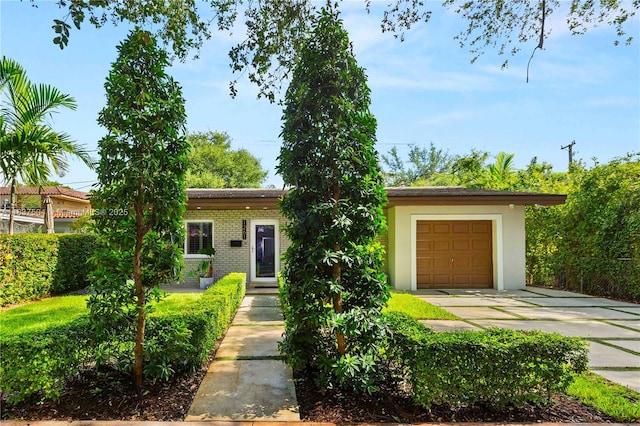 1261 San Miguel Ave, Coral Gables, FL 33134 - view of front of home featuring driveway and brick siding