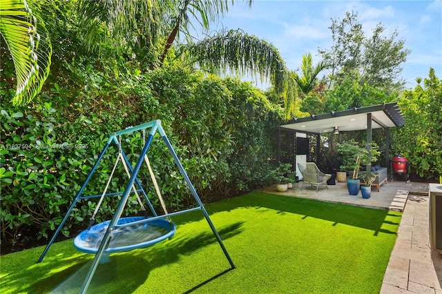 1261 San Miguel Ave, Coral Gables, FL 33134 - view of green lawn featuring a patio area and a playground