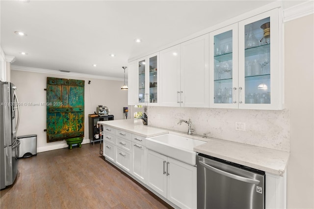 1261 San Miguel Ave, Coral Gables, FL 33134 - kitchen featuring appliances with stainless steel finishes, crown molding, light countertops, tasteful backsplash, and white cabinetry