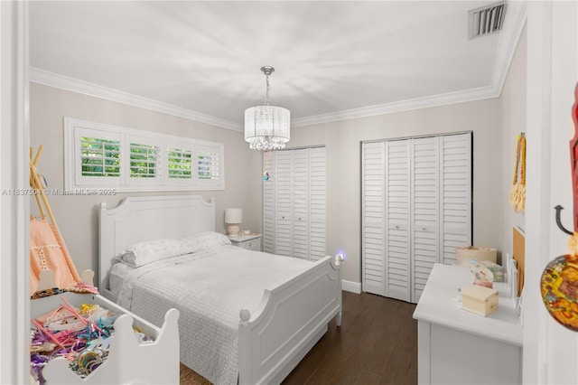 1261 San Miguel Ave, Coral Gables, FL 33134 - bedroom with a chandelier, crown molding, dark wood finished floors, and a closet