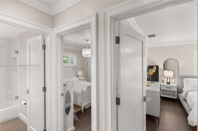 1261 San Miguel Ave, Coral Gables, FL 33134 - hallway featuring dark wood finished floors, crown molding, and a chandelier
