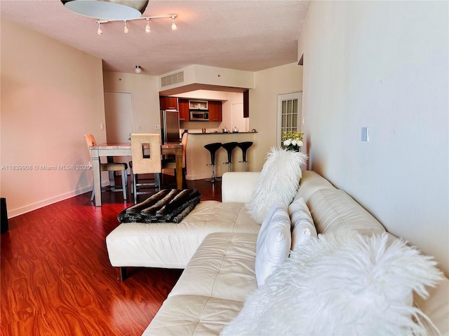 9066 SW 73rd Ct Unit 1409, Miami, FL 33156 - living room featuring dark wood-style flooring and a textured ceiling