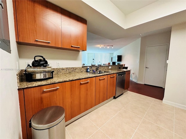 9066 SW 73rd Ct Unit 1409, Miami, FL 33156 - kitchen with dishwasher, brown cabinets, track lighting, light stone countertops, and light tile patterned floors