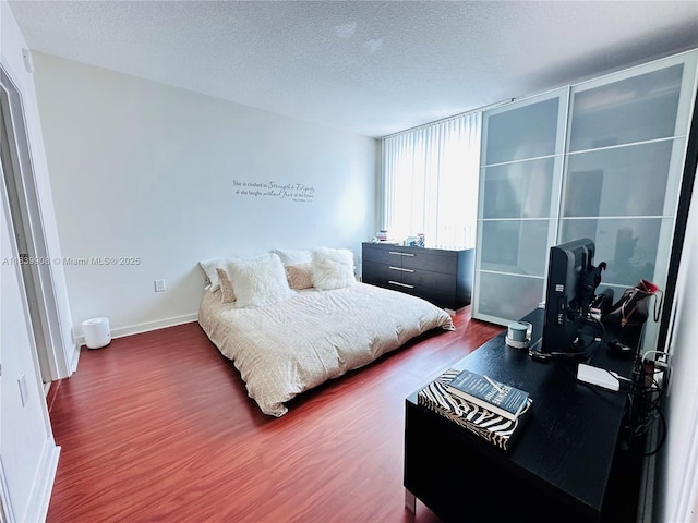 9066 SW 73rd Ct Unit 1409, Miami, FL 33156 - bedroom featuring wood finished floors and a textured ceiling