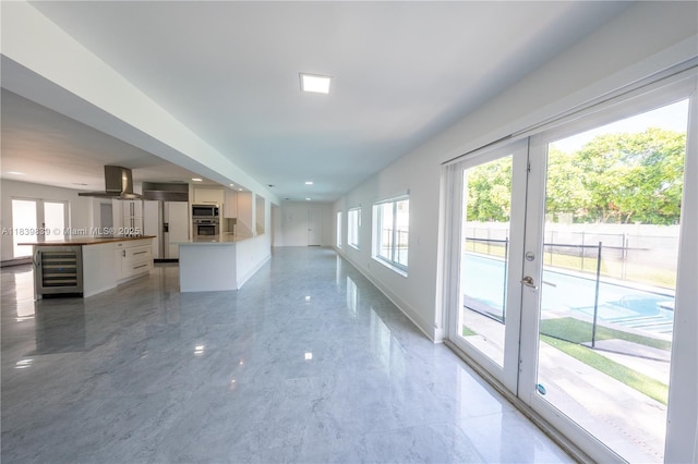 10860 SW 116th St, Miami, FL 33176 - unfurnished living room featuring beverage cooler, french doors, and light marble finish flooring