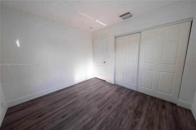 10860 SW 116th St, Miami, FL 33176 - unfurnished bedroom with dark wood-style flooring and a closet