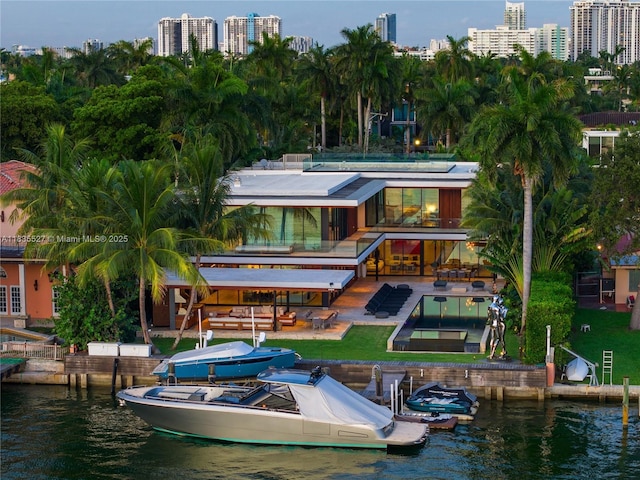 126 W San Marino Dr, Miami Beach, FL 33139 - back of property with a water view and a patio