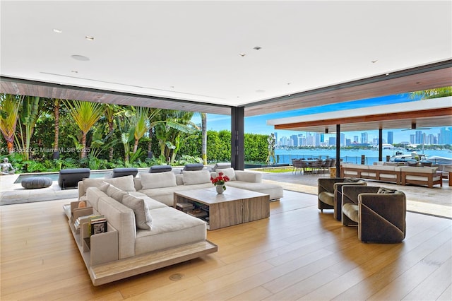 126 W San Marino Dr, Miami Beach, FL 33139 - living area with light wood-style flooring, a city view, and a wall of windows