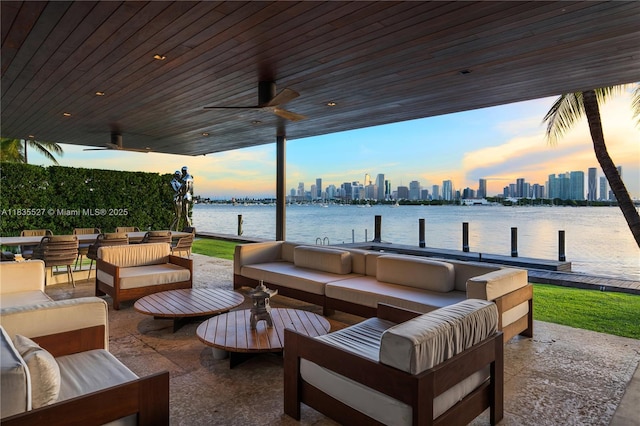 126 W San Marino Dr, Miami Beach, FL 33139 - patio terrace at dusk featuring an outdoor living space, a skyline view, a water view, a ceiling fan, and a dock