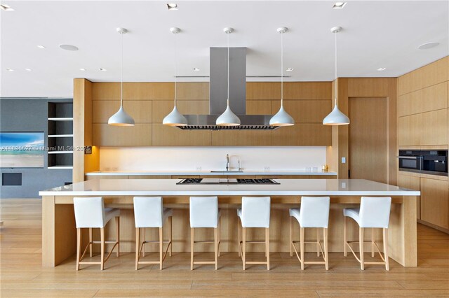 126 W San Marino Dr, Miami Beach, FL 33139 - kitchen with ventilation hood, modern cabinets, gas cooktop, and light countertops