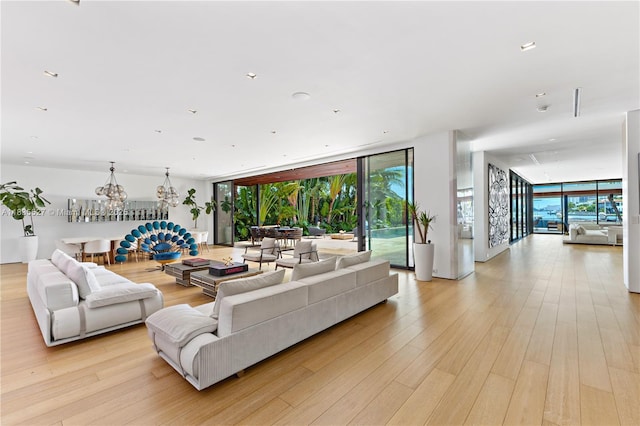 126 W San Marino Dr, Miami Beach, FL 33139 - living room with light wood finished floors, a chandelier, and floor to ceiling windows