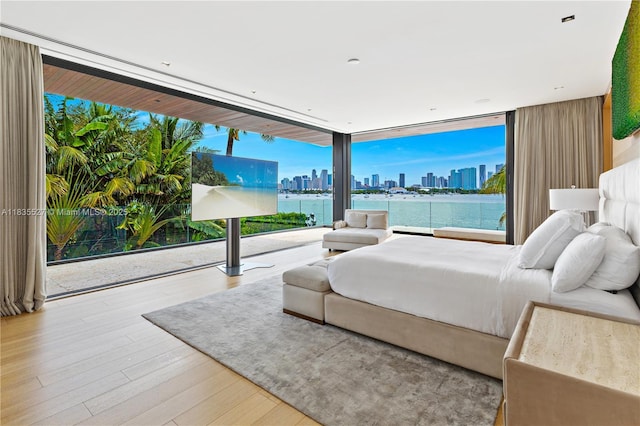 126 W San Marino Dr, Miami Beach, FL 33139 - bedroom featuring a skyline view, wood finished floors, and expansive windows