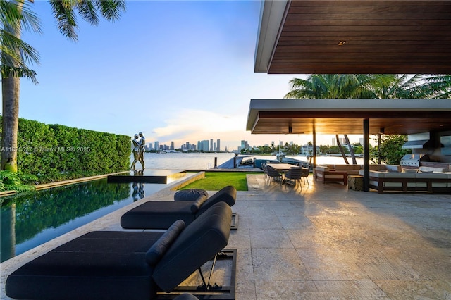 126 W San Marino Dr, Miami Beach, FL 33139 - view of patio / terrace featuring a dock, a view of skyline, an outdoor hangout area, grilling area, and a water view