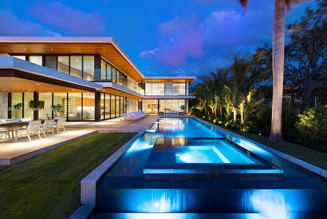 126 W San Marino Dr, Miami Beach, FL 33139 - view of swimming pool with a patio, a pool with connected hot tub, and a yard