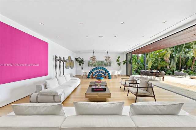 126 W San Marino Dr, Miami Beach, FL 33139 - living room featuring a chandelier and wood finished floors