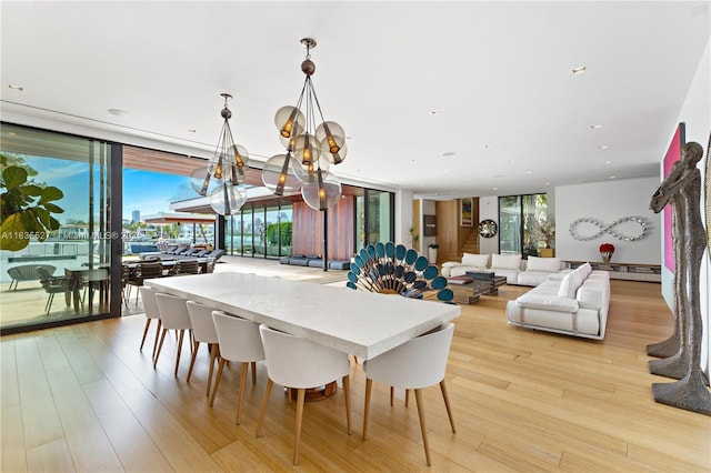 126 W San Marino Dr, Miami Beach, FL 33139 - dining room featuring expansive windows, a chandelier, light wood-type flooring, and recessed lighting