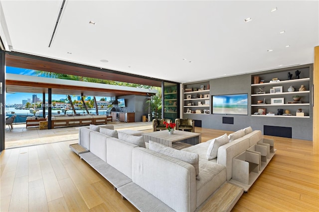 126 W San Marino Dr, Miami Beach, FL 33139 - living room featuring built in shelves and light wood-type flooring