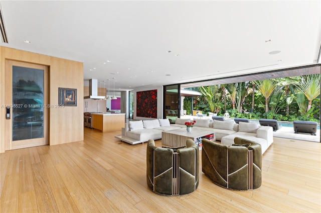 126 W San Marino Dr, Miami Beach, FL 33139 - living room featuring light wood-type flooring and floor to ceiling windows