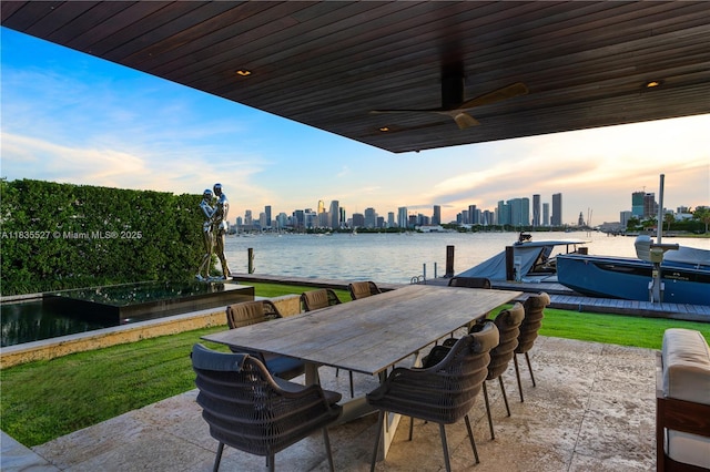 126 W San Marino Dr, Miami Beach, FL 33139 - view of patio / terrace featuring a skyline view, a boat dock, a water view, and outdoor dining area