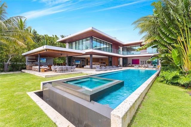 126 W San Marino Dr, Miami Beach, FL 33139 - rear view of house with a patio, a lawn, and a pool with connected hot tub